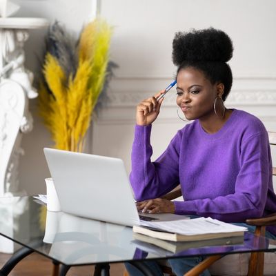 Woman working on computer with a confused look on her face