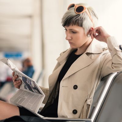 Woman reading newspaper job ad