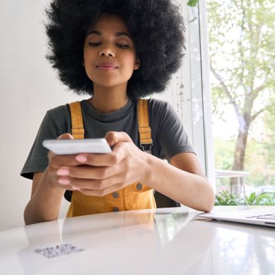 Woman scanning QR code using their phone