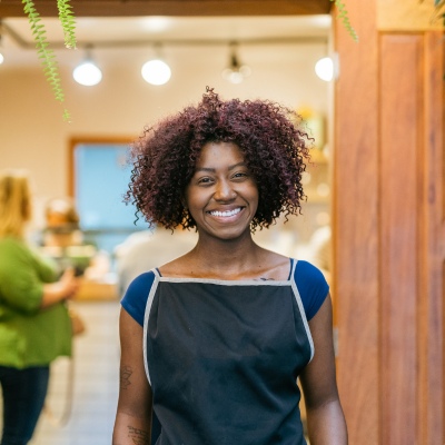 Woman employee smiling being satisfied with employee benefit