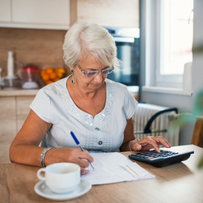 Elderly woman working on her retirement plan paperwork