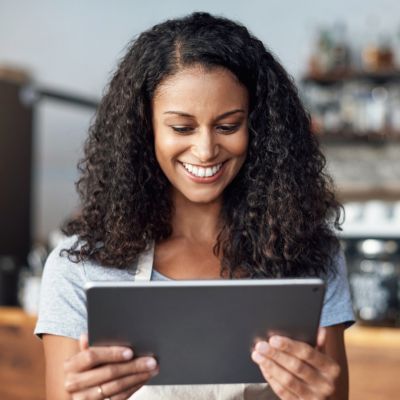 Woman business owner  looking at tablet 