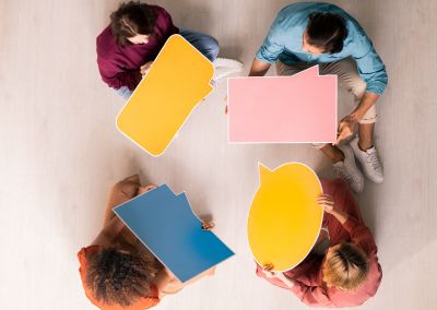 image showing top view of four people holding response cards for survey