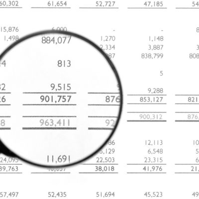 Image showing balance sheets with a magnifying glass 