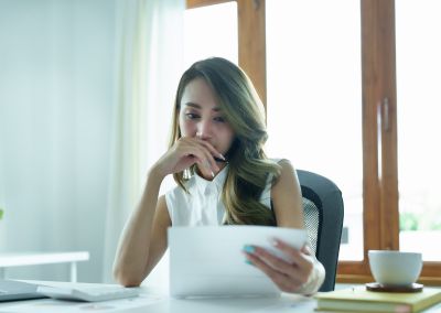 Image showing woman thinking looking at a paper